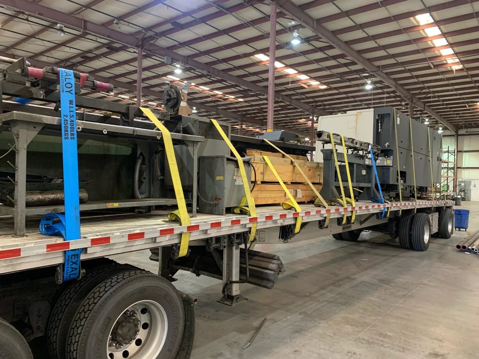 Heavy equipment secured flatbed trailer moving company AZVIR